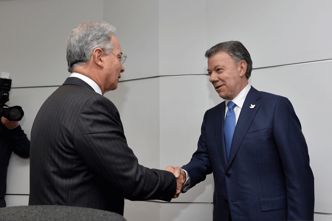Former Colombian President Álvaro Uribe greets President Juan Manuel Santos at Nariño Palace in Bogotá, Colombia, on 5 October 2016. REUTERS/Colombian Presidency